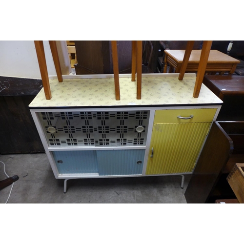 323 - A 1960's kitchen table, sideboard, two stools and a chair