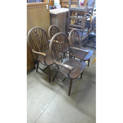 354 - A set of four elm and beech wheelback chairs