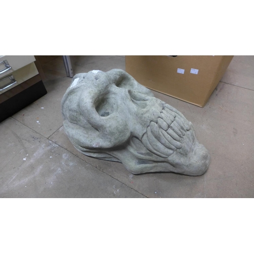 381 - A concrete primate skull garden ornament