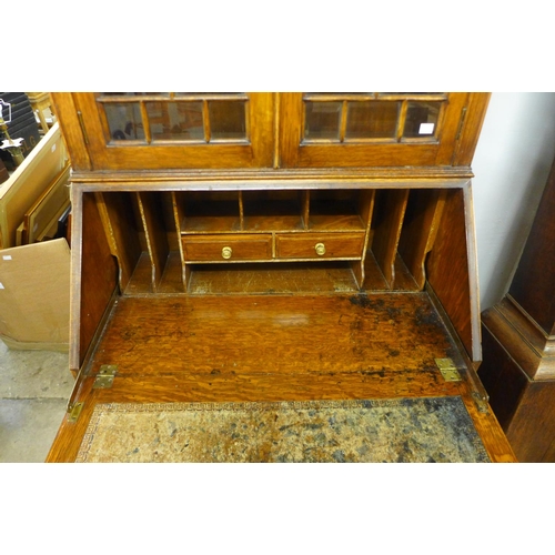 56 - An early 20th Century oak bureau bookcase, 195cms h, 80cms w, 47cms d