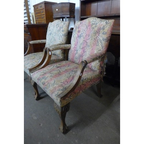 75 - A pair of 1930's carved mahogany and upholstered Gainsborough style open armchairs