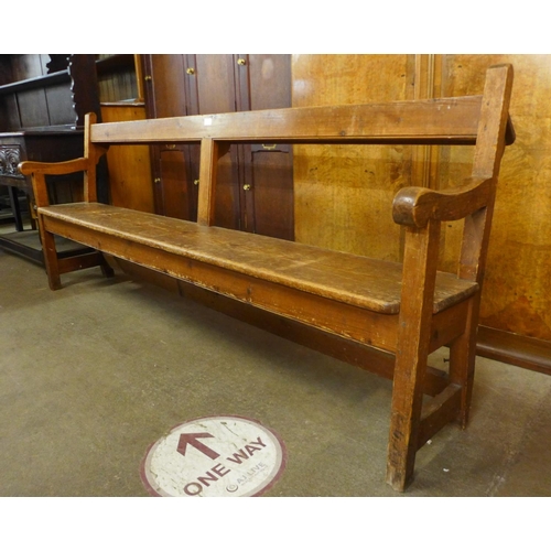 76 - An early 20th Century pine church pew, 86cms h, 204cms w, 50cms d