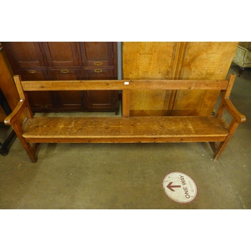 76 - An early 20th Century pine church pew, 86cms h, 204cms w, 50cms d