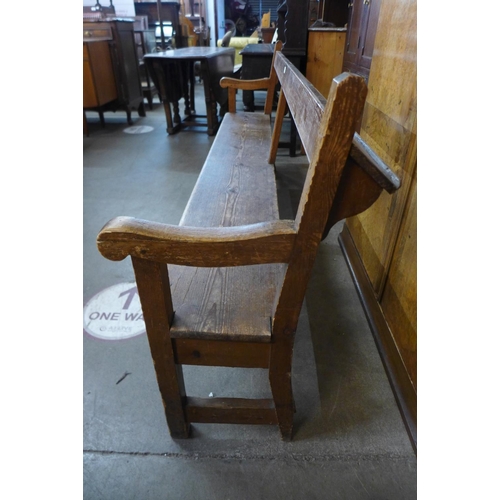 76 - An early 20th Century pine church pew, 86cms h, 204cms w, 50cms d