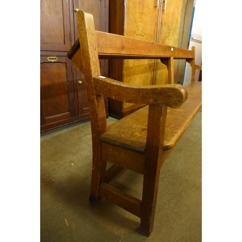 76 - An early 20th Century pine church pew, 86cms h, 204cms w, 50cms d