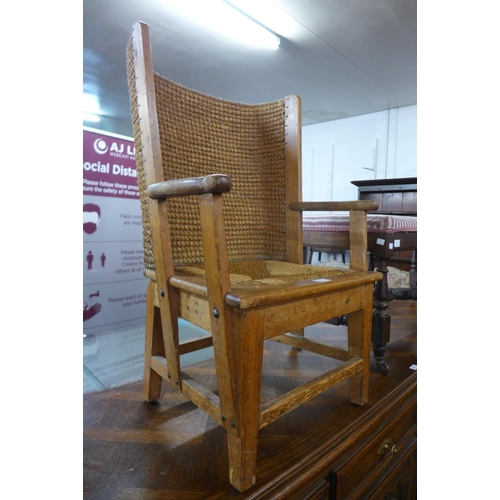 81 - An Orkney pine and straw work child's chair, 83cms h x 54cms w