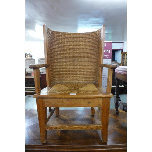 81 - An Orkney pine and straw work child's chair, 83cms h x 54cms w