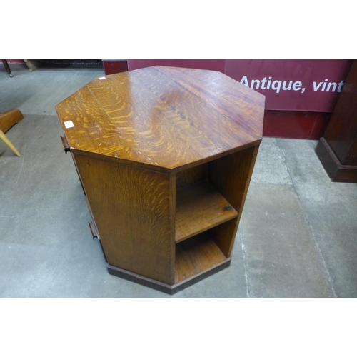 95 - An Art Deco Heals style oak octagonal book table 62cms h, 64cms w, 64cms d