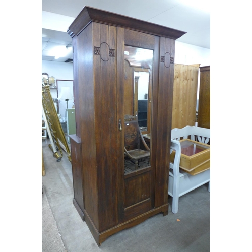 442 - An Arts and Crafts oak wardrobe