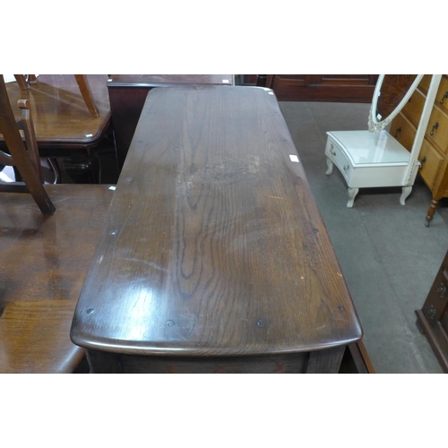 325 - An Ercol Old Colonial dark elm dresser, refectory table and six ladderback chairs