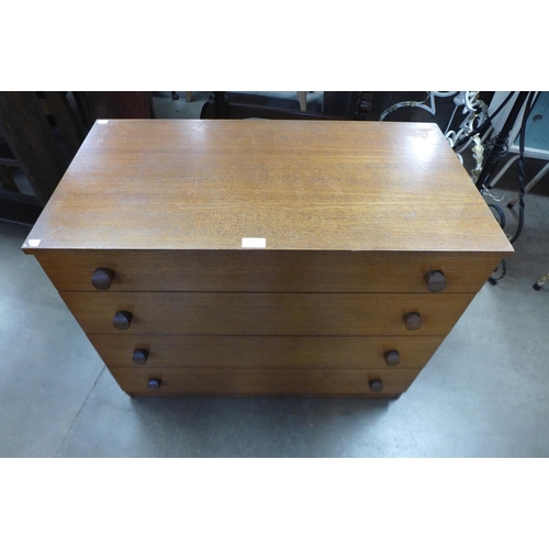 330 - A teak chest of drawers, a/f, a mahogany dining table and three chairs