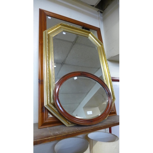 412 - A pine mirror, a gilt framed mirror and an oval mahogany mirror