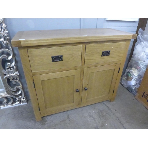 1345 - An oak two door, two drawer sideboard  *This lot is subject to VAT