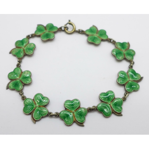 1031 - A white metal and enamel shamrock bracelet