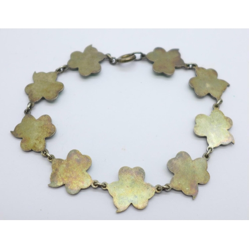 1031 - A white metal and enamel shamrock bracelet