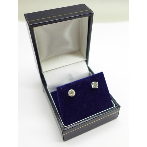 1036 - A pair of 18ct white gold and diamond stud earrings, total diamond weight 0.77carats