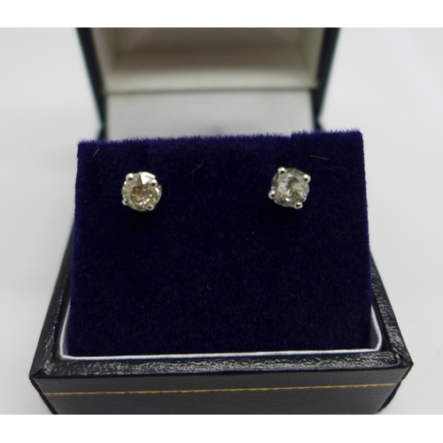 1036 - A pair of 18ct white gold and diamond stud earrings, total diamond weight 0.77carats