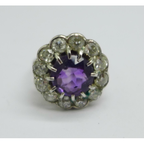 1042 - A platinum, amethyst and diamond cluster ring, marked 'plat', 5.8g, M, ring top 15mm