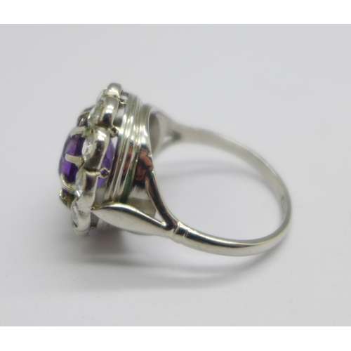 1042 - A platinum, amethyst and diamond cluster ring, marked 'plat', 5.8g, M, ring top 15mm