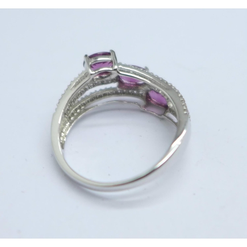 1054 - A 9ct gold, magenta garnet and white sapphire ring, 3.4g, S