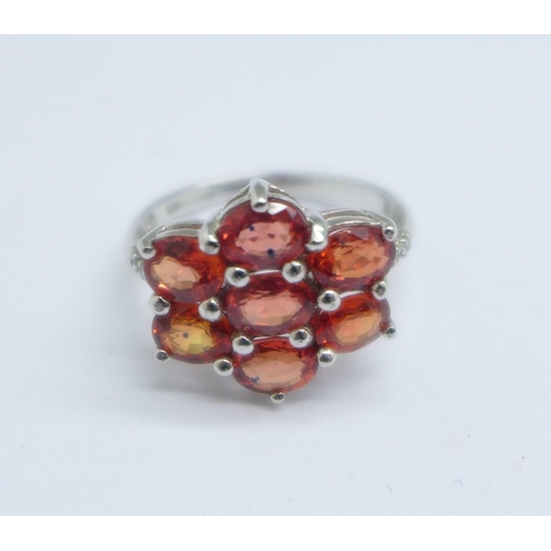 1056 - A 9ct white gold, hessonite garnet cluster ring, with diamond shoulders, 3g, K