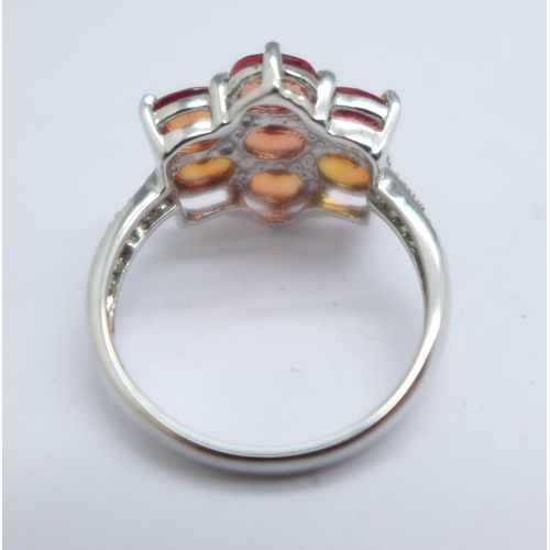 1056 - A 9ct white gold, hessonite garnet cluster ring, with diamond shoulders, 3g, K