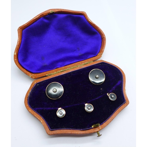 1062 - A cased set of yellow metal, onyx and seed pearl studs, 7.8g