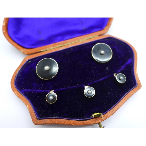 1062 - A cased set of yellow metal, onyx and seed pearl studs, 7.8g