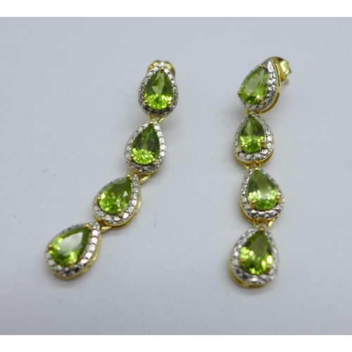 1063 - A pair of silver gilt and peridot drop earrings