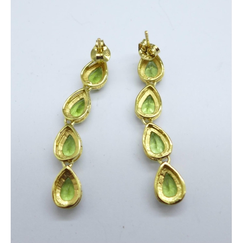 1063 - A pair of silver gilt and peridot drop earrings