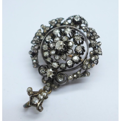 1064 - A 19th Century old cut diamond set pendant or brooch, set with over 100 diamonds, the centre stone a... 