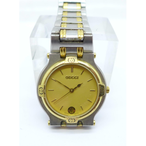 1101 - A yellow metal and stainless steel Gucci dress wristwatch