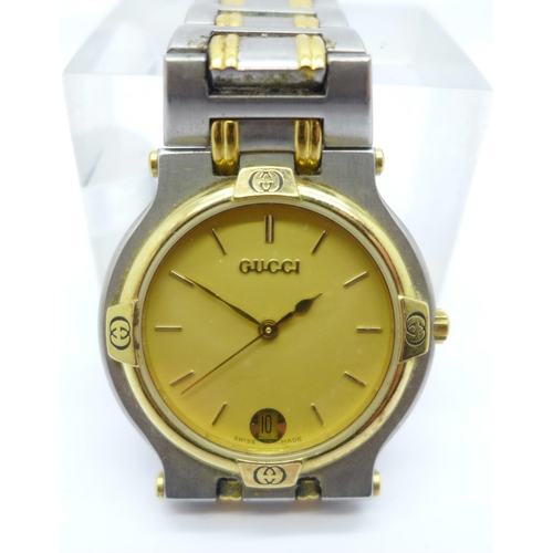 1101 - A yellow metal and stainless steel Gucci dress wristwatch