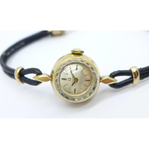 1110 - A lady's hallmarked 9ct gold Omega wristwatch, the 'shoelace' strap mount also marked 9ct gold