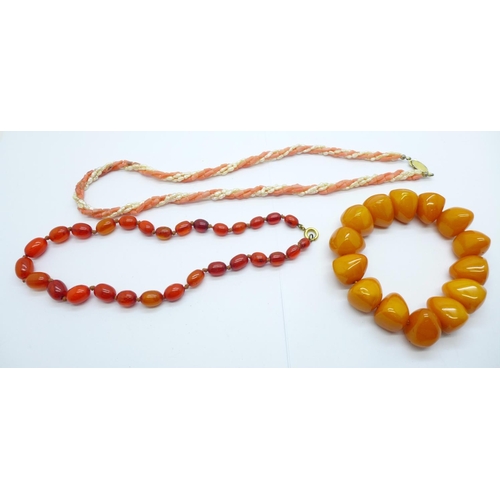 1148 - A coral and pearl necklace, one other necklace and an amber coloured bracelet