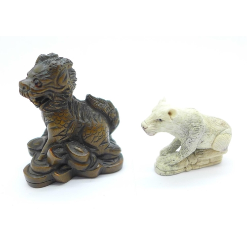 1149 - A signed Kirin netsuke and a carved lion, lion a/f