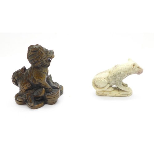 1149 - A signed Kirin netsuke and a carved lion, lion a/f