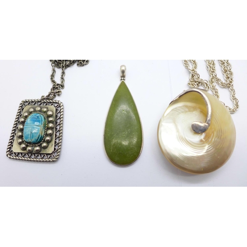 1151 - Two silver mounted pendants, a silver chain and a white metal scarab beetle pendant and chain