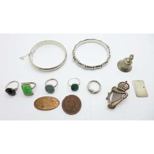 1152 - Two silver bangles, an Irish regimental badge, a silver date pendant, three silver rings, two other ... 