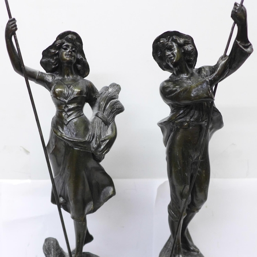 607 - A pair of spelter figures, farm girl and boy, 39.5cm