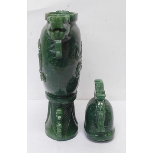 629 - A carved green stone urn with lid, small losses to the lid and one ring missing, 23cm