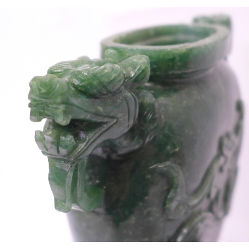 629 - A carved green stone urn with lid, small losses to the lid and one ring missing, 23cm