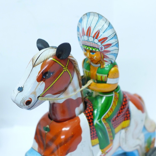 643 - A tin-plate clockwork clown and a T.T. made in Japan 'Indian' Chief on horse