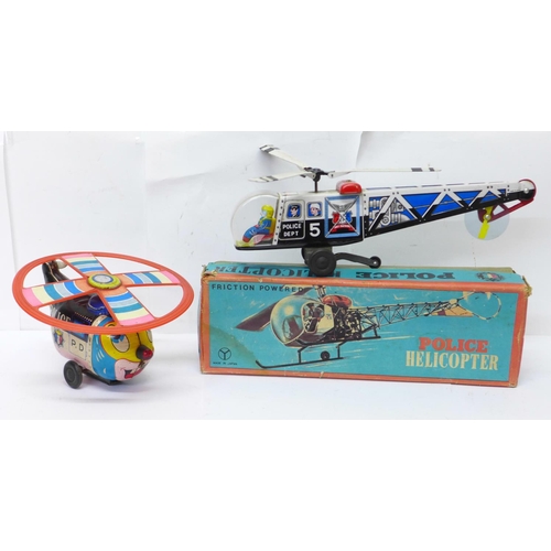 644 - A Friction Powered tin-plate Police Helicopter, made in Japan, boxed, and a T.N. made in Japan tin-p... 