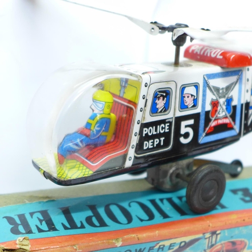 644 - A Friction Powered tin-plate Police Helicopter, made in Japan, boxed, and a T.N. made in Japan tin-p... 