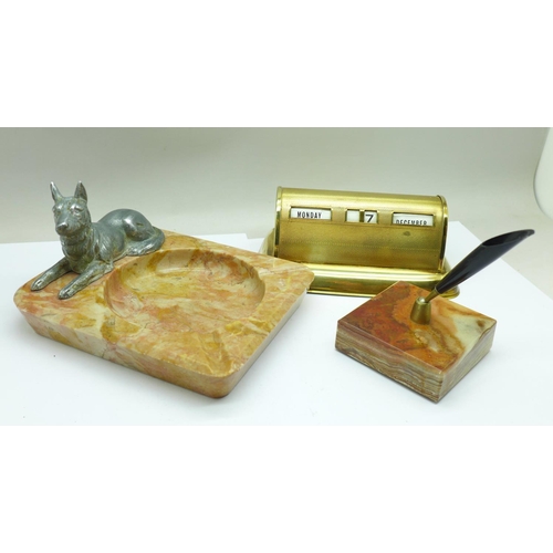 657 - A Stratton perpetual desk calendar, a pen holder on an onyx base and a hardstone ashtray mounted wit... 