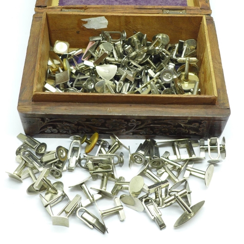 677 - A carved wooden box with cufflinks and cufflink parts