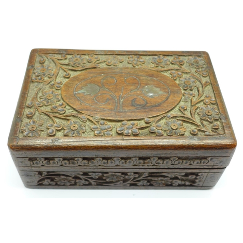 677 - A carved wooden box with cufflinks and cufflink parts