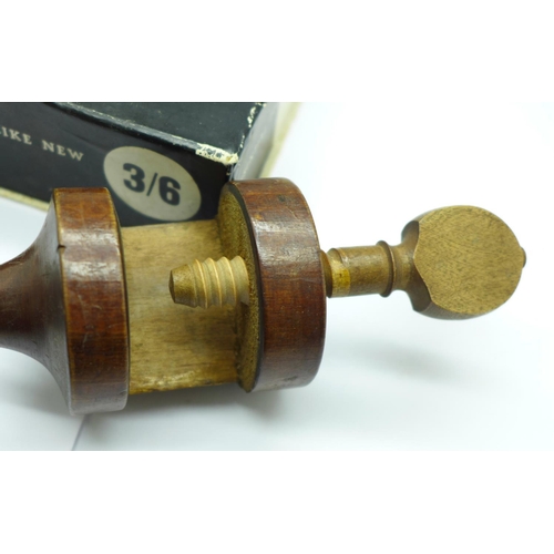 678 - A silver thimble in fitted case, a needle sharpener and a wooden cotton reel holder clamp