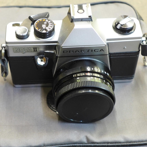 697 - A Praktica Nova TL 35mm film camera with teleconverter flash unit, Carl Zeiss Jena Teosar 2.8/50 len... 